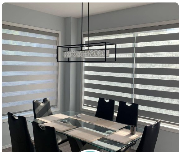 Commercial boardroom with a glass table and zebra blinds along the window wall