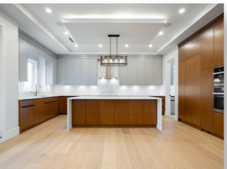 Contemporary kitchen with a long island and walnut cabinetry
