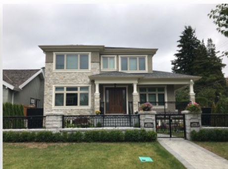 Two-storey family home with stone facade and front lawn