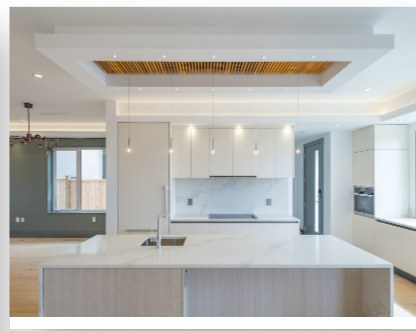 Open-plan kitchen with a coffered ceiling and white island