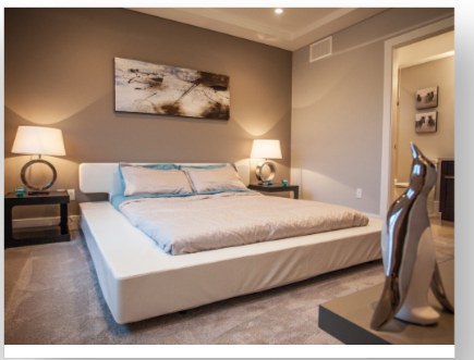 Bedroom with a platform bed and neutral finishes