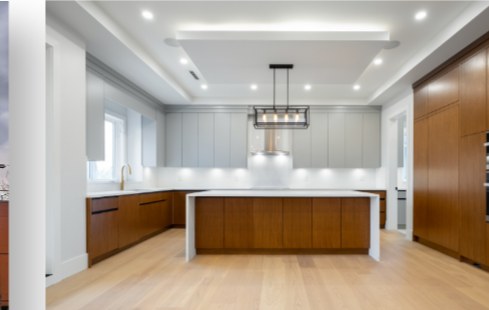 Contemporary kitchen with a long island and walnut cabinetry
