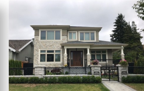Two-storey family home with stone facade and front lawn