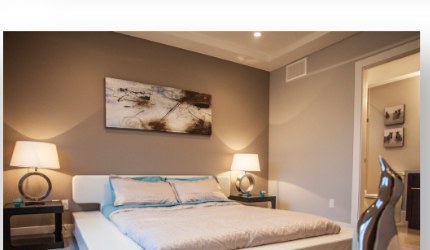 Bedroom with a platform bed and warm neutral finishes